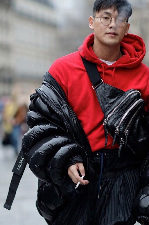 Eugene Lim in a red hoodie and black outerwear